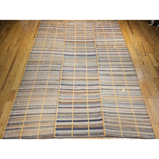 A striking 19th century American Amish rag rug, room-size and composed of three expertly joined woven runners to form one...