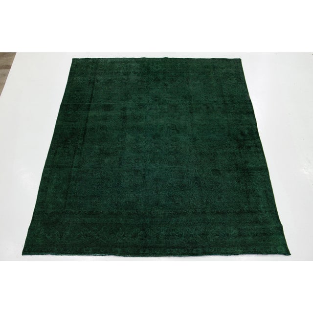 This exquisite vintage hand-knotted wool Persian rug showcases a green field. It features a stunning all-over floral...