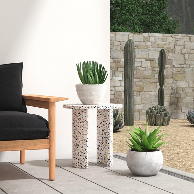 With gorgeous crescent-shaped legs and a round top, this outdoor terrazzo-style table offers a playful and earthly look...