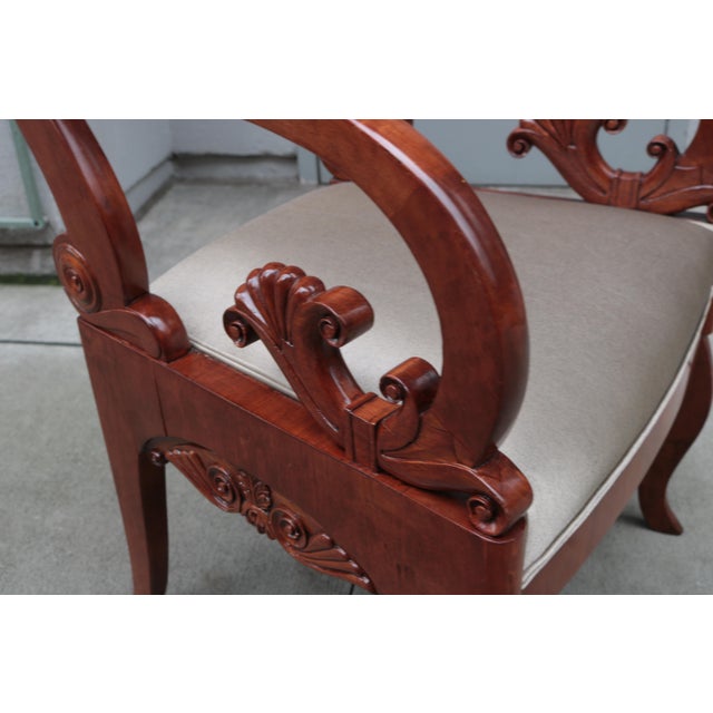 A fine pair of Empire armchairs. Solid mahogany with fine carved details throughout.