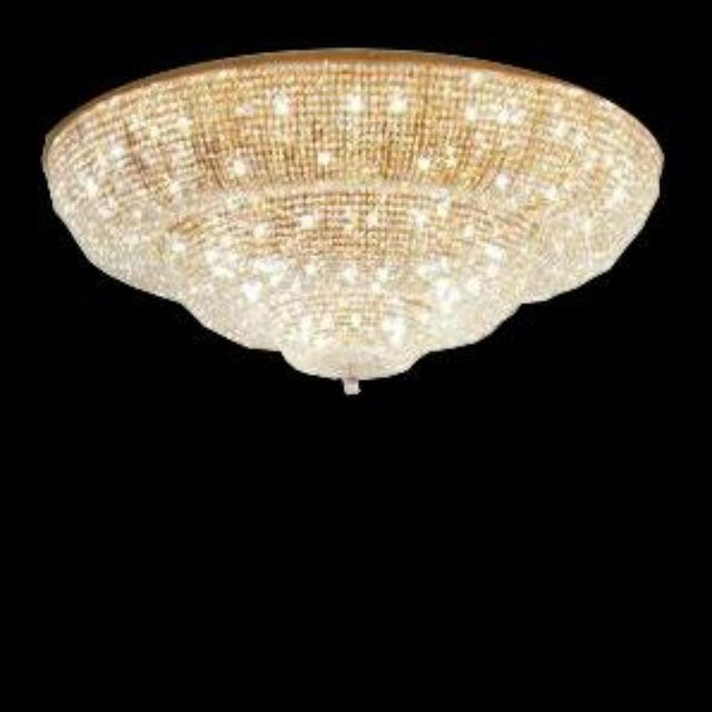 Empire 36 lights flush mount in gold plate and full cut crystal by aggiolight. Dimensions: d 180 x h 90 cm. Materials:...