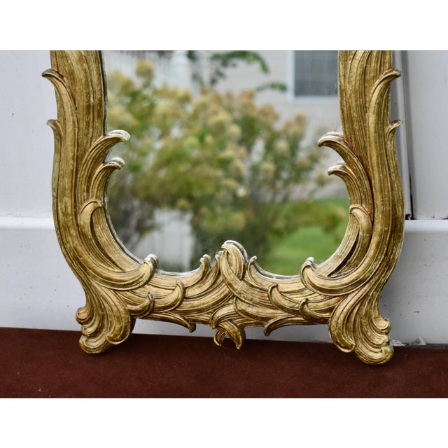 Vintage (1960's) Ornate Wall Mirror with a Burnished Gold Finish and a Hollywood Regency Style. The Measurements: 14"W x...