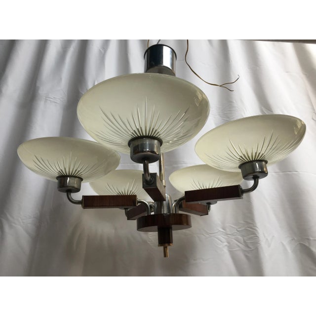Art-Deco chandelier from the 1920s. Beautiful hand cut lampshades. Walnut wood.Chrome metal. European Plug (up to...