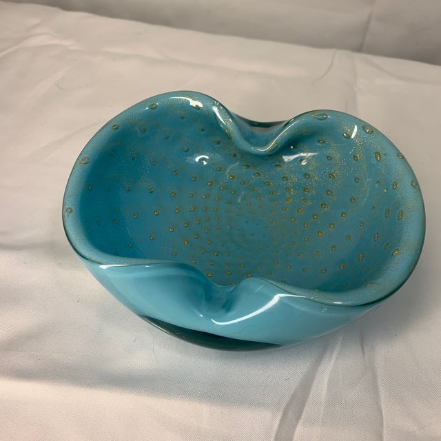 This is a vintage mid-century Murano turquoise art glass bowl featuring a textured bubble pattern accented with delicate...