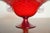 A striking vintage ruby red Murano art glass footed compote featuring a wide flared bowl, short pedestal base, and applied...