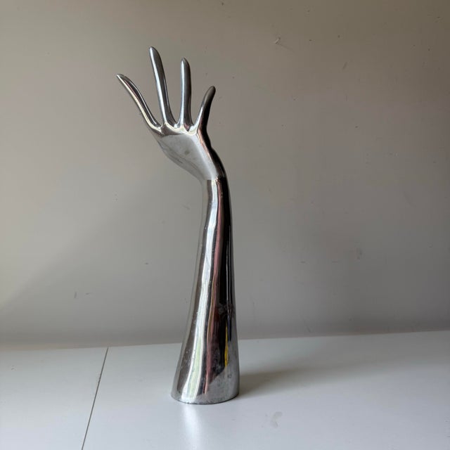 Vintage cast aluminum chrome hand sculpture. This piece is quite interesting given its fluid details and quite sizable. It...