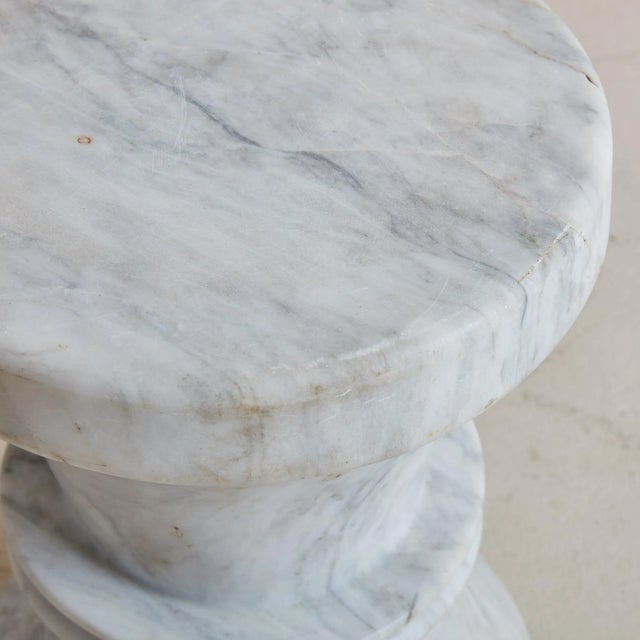 A 20th Century petite stool entirely crafted from solid white Italian Carrara marble. This Modern stool resembles a chess...
