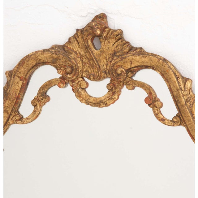 Baroque Style Giltwood Framed Mirror. Mirror Plate: 38" H x 29" W; frame: 48" H x 32" W x 1.5" D. Provenance: From a New...