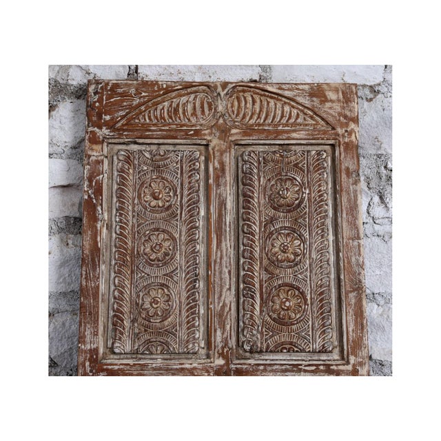 This vintage floral carved barn door is a striking example of reclaimed craftsmanship, rich in history and natural...