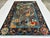 This hand-knotted Afghan pictorial rug centers a single flowering tree filled with exotic birds, surrounded by a rabbit,...