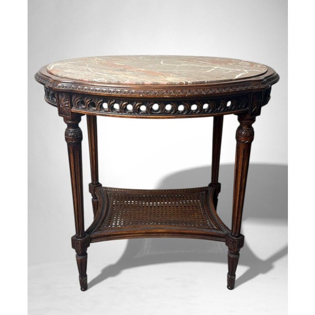 Elegant Italian side table from the early 20th century, crafted in finely worked solid walnut and enriched by a refined...