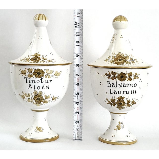 Offering a large pair of ceramic Italian Majolica hand painted Apothecary Jars, circa 1950s. These beautiful jars are in...