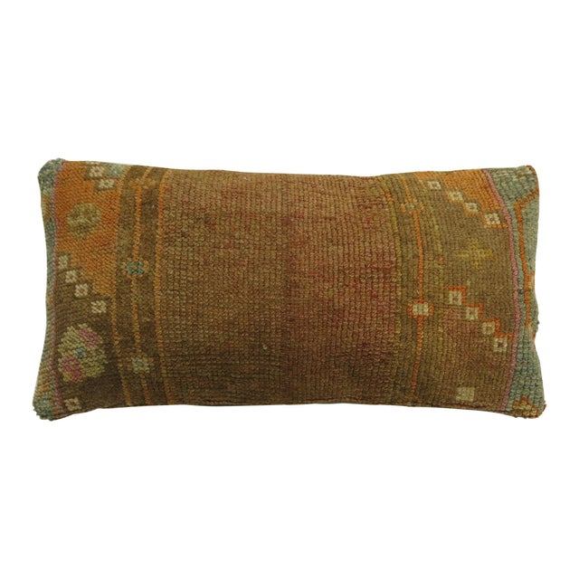Bolster size pillow made from a vintage Turkish Anatolian rug. Brown, orange, soft green, lavender accents Measures: 11''...