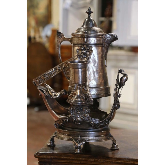 Richly ornamented with figural and botanical motifs, this antique silver-plated copper samovar was crafted in the United...