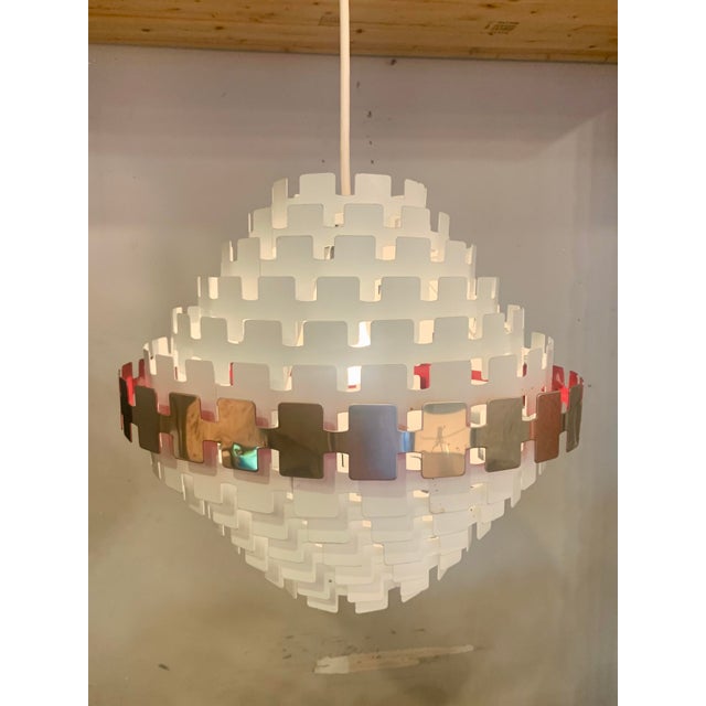 New old stock, never used, in its original box from 1970 and packed in straw, Sculptural Concentric Metal Ring Pendant...