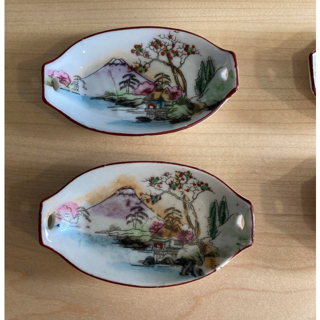 A beautiful vintage Japanese porcelain sushi serving set consisting of one large serving tray and six matching dipping...