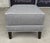 This Ethan Allen gray upholstered ottoman features a textured fabric, crisp white piping, and dark tapered wood legs for a...
