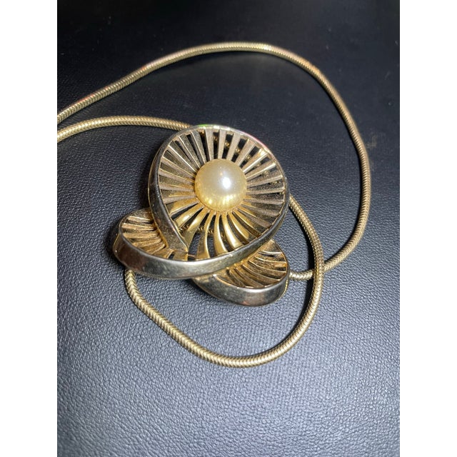 Marcel Boucher MCM pendant necklace. With openwork pierced ribs radiating like a stylized sunburst from a smooth central...
