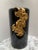 Vintage glossy black and gold Italian vessel or vase with draped textural gold ginkgo flowers bursting over one side....