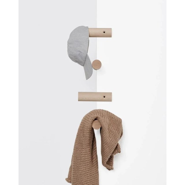 HOOK is a cylindric round wood that adjusts itself and thus becomes a little helper at every corner. Whether it be a wall...