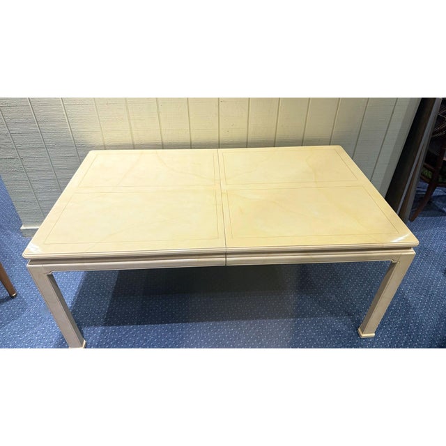 This Henredon dining table features a faux goatskin lacquered finish, giving it a unique and elegant appearance. The table...