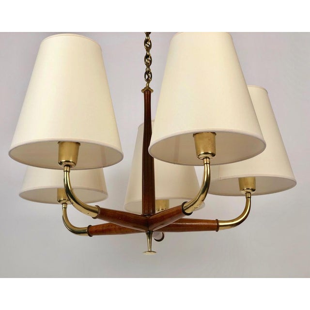 A beautiful five arm pendant lamp from josef frank in brass and walnut. The wood and brass elements exhibit a lovely...