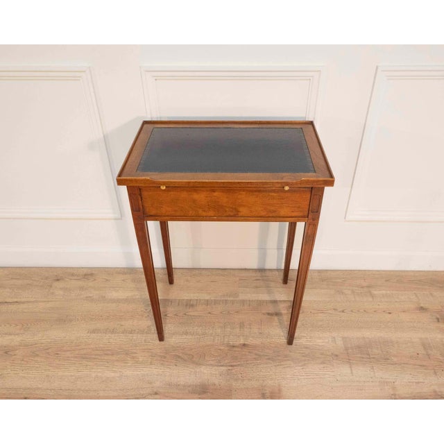 This elegant Louis XVI–style side table is crafted in cherry wood and features refined, classical proportions...