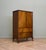 A compact 1930s walnut tallboy linen cupboard by renowned British furniture maker Waring & Gillow. Featuring figured...