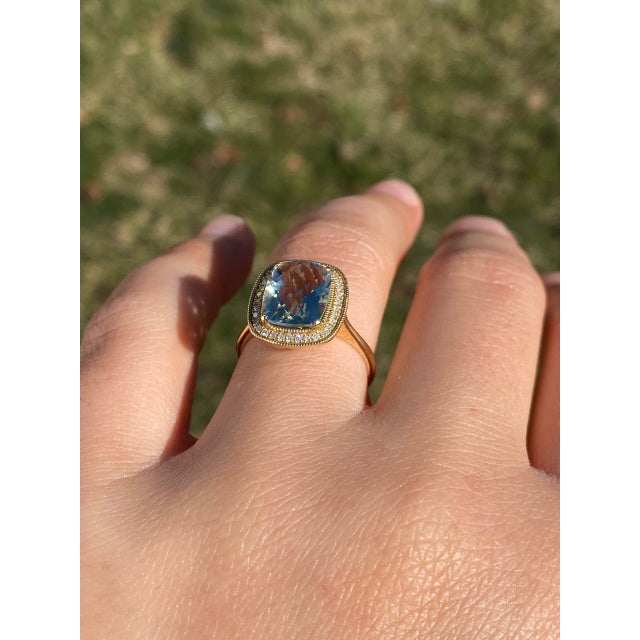 The Edalat: Praisiolite and Natural Diamond Halo Ring in Yellow Gold. This exquisite ring features an elongated...