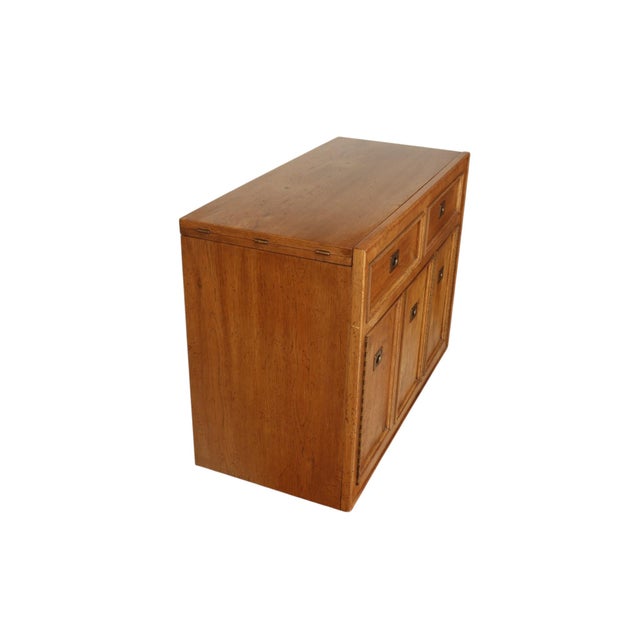 A 1970’s campaign style buffet/server made by American of Martinsville. The cabinet top slides and lifts revealing a black...