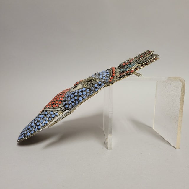 A vibrant wall mask of Lord Ganesh, hand-worked in repoussé brass with a silver-tone (nickel-silver) filigree overlay and...