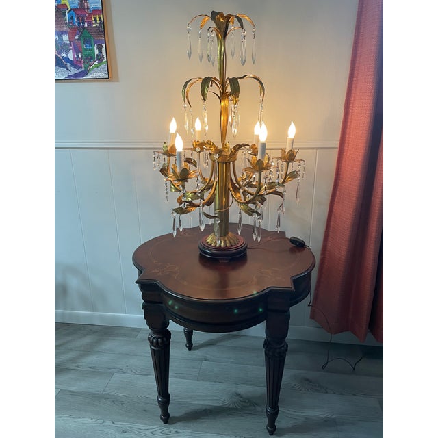 A glamorous Italian Hollywood Regency style Gilt Tole Table Lamp with six candelabra bulbs and beautiful crystal prism...