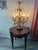 A glamorous Italian Hollywood Regency style Gilt Tole Table Lamp with six candelabra bulbs and beautiful crystal prism...