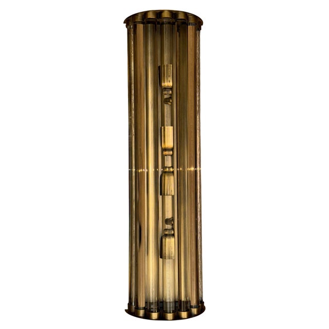 Elegant large-scale Italian Mid-Century Modern wall sconce, dating to circa the 1970's, combining architectural brasswork...