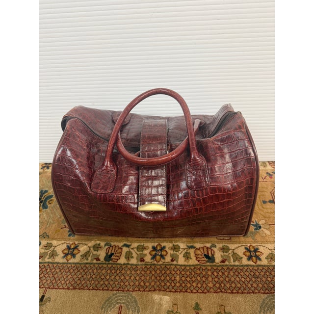 Design Plus Gallery presents a Maroon Leather Satchel Travel Bad of Embossed Printed Crocodile. A staple for any well-...