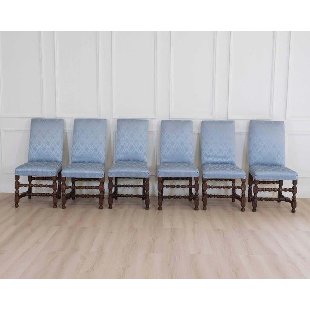 A handsome set of six Lombard walnut dining chairs from the first half of the 18th century, distinguished by their classic...
