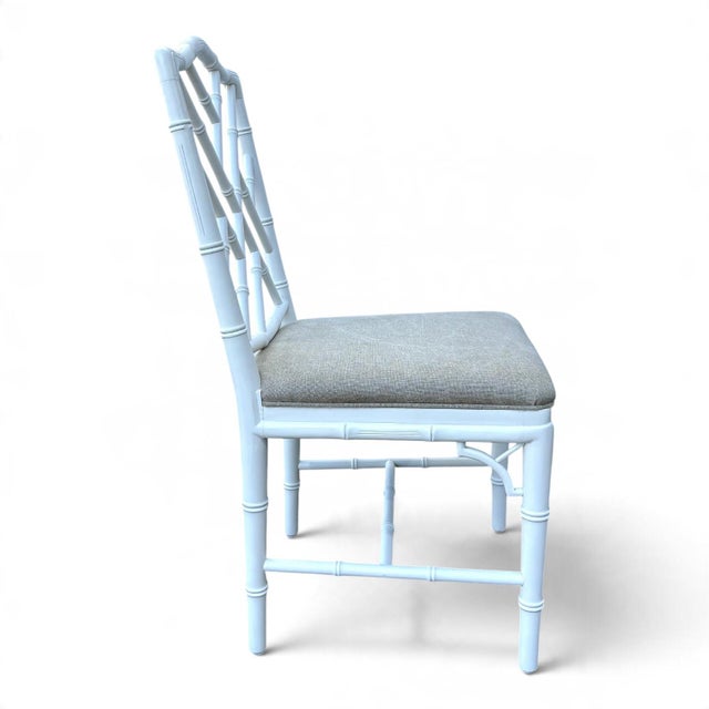 A set of 6 faux-bamboo dining chairs . The seats are covered in linen.