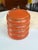 A rare atomic piece! This is an orange pagoda style canister set, stacked to perfection with a beautiful patina. Scratches...