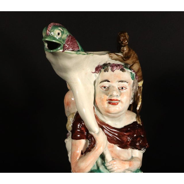 Revelry in Relief: A Magnificent Staffordshire Pearlware Bacchus Jug This monumental English Pearlware Pottery Jug offers...