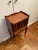 Fruit wood library bookbinding side table with a small cabinet. Cabinet door is covered in leather book bindings for...