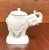 An Asian style candy dish in the shape of an elephant by Andrea by Sadek. Hand painted, white in color glazed porcelain of...