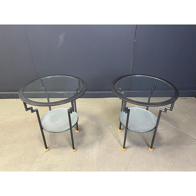 Vintage postmodern style round side tables with a metal frame and two tier glasses. Inspired by Ettore Sottsass's designs....