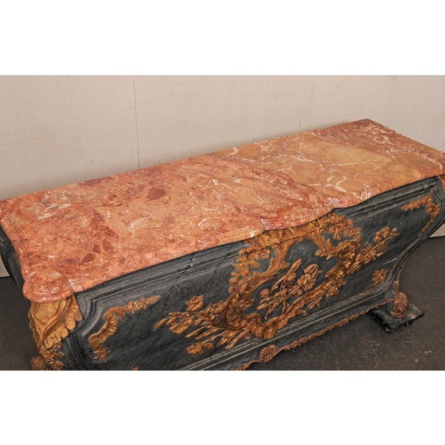 A stunning Italian Rococo period bombe console, with shapely serpentine marble top, from the 18th century. This antique...