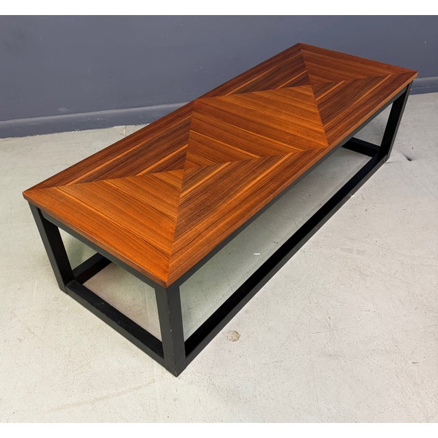 Handsome mid-century modern coffee table by Founders, featuring a richly grained walnut veneer top with striking geometric...