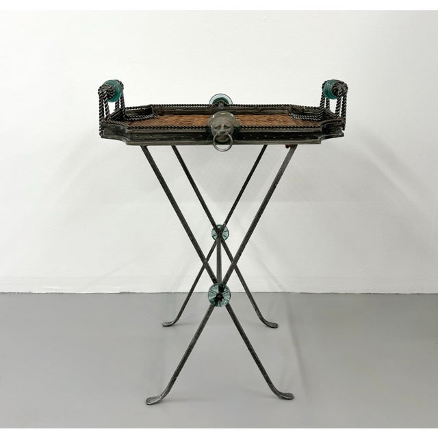 A distinctive vintage tray table by Maitland-Smith featuring a woven rattan tray top framed in dark patinated metal....