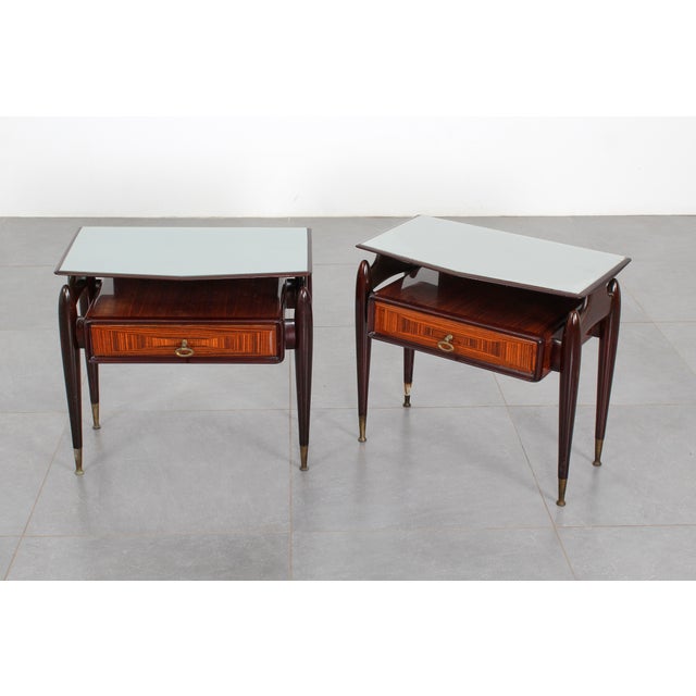 Pair of wooden nightstands with a shaped silvered glass top and a central drawer with a veneered front. Made by Dassi...