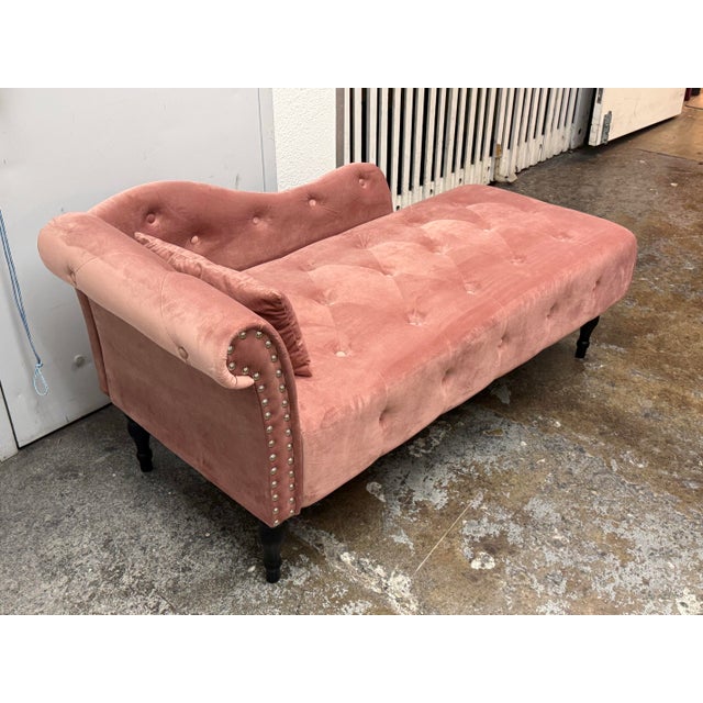 Design Plus Gallery presents a Hollywood Regency Blush Velvet Chaise Lounge. It has tufted upholstery, a scrolling back,...