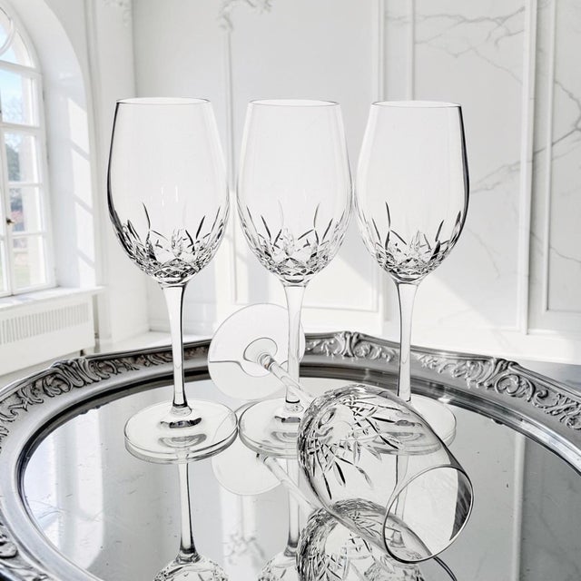 Set of four Waterford Crystal Lismore Essence white wine glasses produced in Ireland. The glasses feature the Lismore...