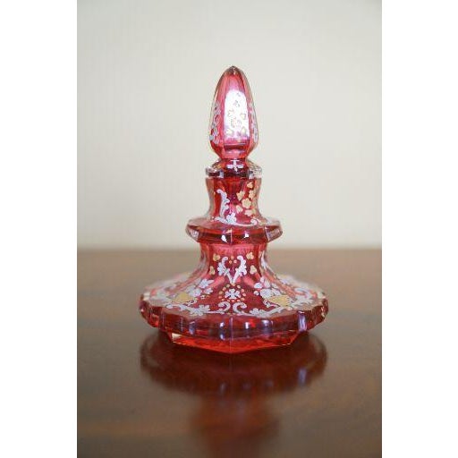 A beautiful antique Bohemian cranberry glass perfume bottle, dating to the 19th century, with faceted form, fitted...