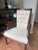 Traditional button-tufted backrest with airy woven can side wings. Creamy, diamond-dot patterned upholstery. Beautiful...